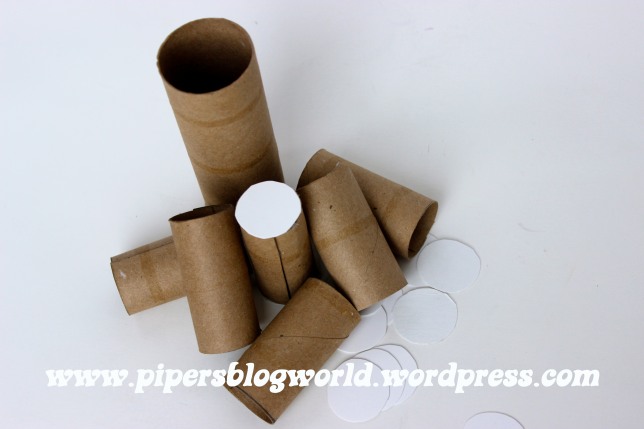 Once again, I dove into my recycle box and retrieved several toilet paper tubes. I cut them down to size for the bolsters and glued circles at the ends. Then I covered them with batting and fabric.