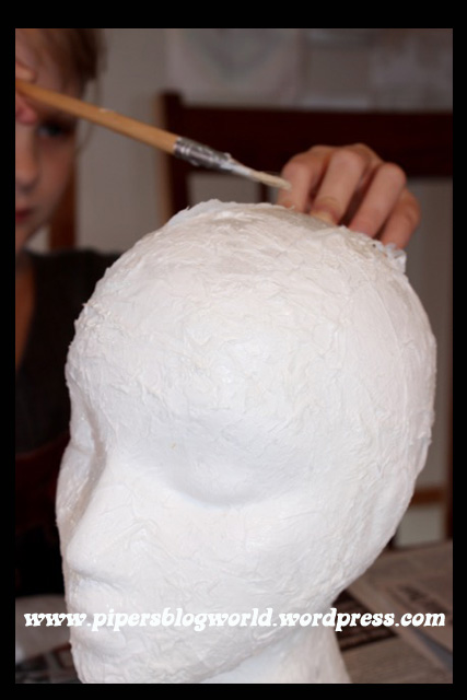 Piper mod podged tissue paper all over the styrofoam head.