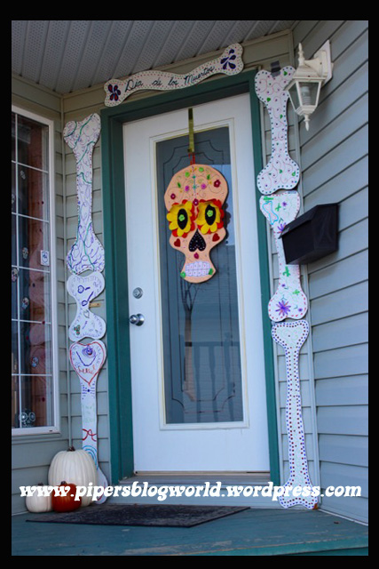 Piper painted cardboard bones to place around the front door frame.