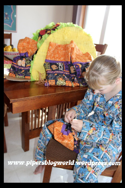I sewed little sacks for each party guest and filled them with organic treats. Piper tied them and placed them in the taco piñata.